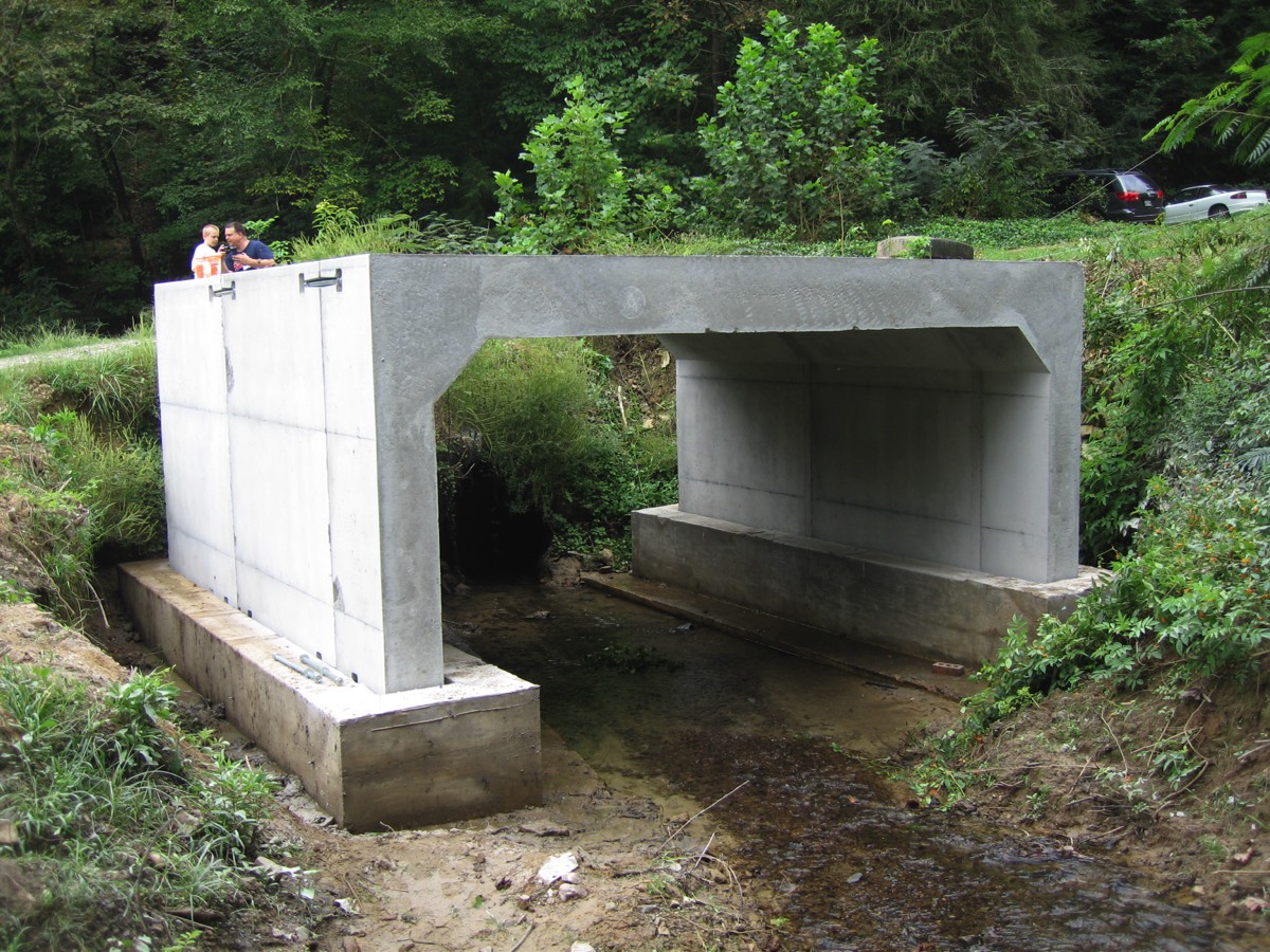 Three sided box culvert with pour-in-place footer